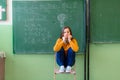 Teenager girl in math class overwhelmed by the math formula. Pressure, Education, Success concept. Royalty Free Stock Photo