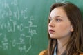 Teenager girl in math class overwhelmed by the math formula. Pressure, Education. Royalty Free Stock Photo