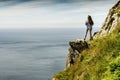 Teenager girl in a mountains, enjoys great view on the ocean
