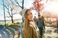 Teenager, girl in nature with friends and walk in park with autumn and sunshine, wellness with happy in portrait. Youth