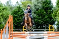 Young girl participating in a show jumping competition with her mare Royalty Free Stock Photo