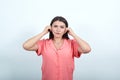 Teenager girl over white wall frustrated and covering ears with hands