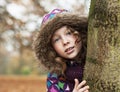 Teenager girl poking around a tree Royalty Free Stock Photo