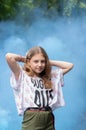 Teenager girl posing with raised arms. Hands behind your head