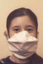 Teenager girl in a protective mask. Little girlwearing a surgical mask, Virus protection concept. vertical photo. close up toned Royalty Free Stock Photo