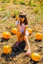 Teenager girl and pumpkin in the vegetable garden. A girl with a pumpkin wearing glasses for Halloween Royalty Free Stock Photo