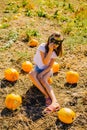 Teenager girl and pumpkin in the vegetable garden. A girl with a pumpkin wearing glasses for Halloween Royalty Free Stock Photo