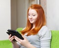 Teenager girl reads e-book Royalty Free Stock Photo