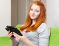Teenager girl reads e-reader or tablet computer Royalty Free Stock Photo