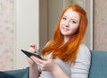 Teenager girl reads tablet computer at home Royalty Free Stock Photo