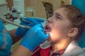 teenager girl at a reception in the office at the dentist sitting in a chair. Dentistry, pain,