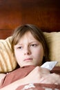 Teenager girl sick with flu lying in bed