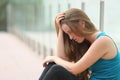 Teenager girl sitting outdoor depressed