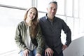 Teenager girl sitting on window with father Royalty Free Stock Photo