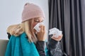 Teenager girl sneezing in handkerchief, female with symptoms of illness sitting at home Royalty Free Stock Photo