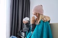 Teenager girl sneezing in handkerchief, female with symptoms of illness sitting at home Royalty Free Stock Photo