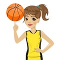 Teenager girl spinning basketball ball with her finger