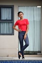 Unemotional Teenager Girl Standing By Condo