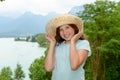 Teenager girl with a straw hat in the wild