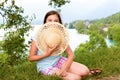 Teenager girl with a straw hat in the wild