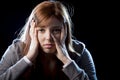 Teenager girl in stress and pain suffering depression sad and scared in fear face expression Royalty Free Stock Photo