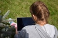 Teenager girl studying on a laptop. Distance education. Happy schoolgirl in Park with computer Royalty Free Stock Photo