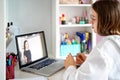 Teenager girl studying online at home looking at teacher giving lesson at laptop screen Royalty Free Stock Photo