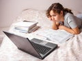Teenager girl studying online at home. School girl with lap top on the bed. Home education Royalty Free Stock Photo