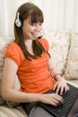 Teenager girl talking with headset and laptop