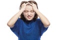 A teenager girl thinks holding her head and closing her eyes. Close-up. Isolated on a white background