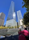 Teenager girl tourist admiring the Freedom Tower and fountain in New York City