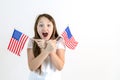 Teenager girl with two american flags in hand on a white background. The concept of education in the United States