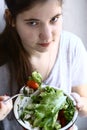 Teenager girl vegan with salad bowl close up photo