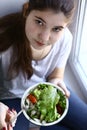 Teenager girl vegan with salad bowl close up photo