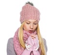 Teenager girl in winter hat and scarf warming hands