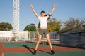 Teenager girl working out at the stadium doing jumping jacks Royalty Free Stock Photo