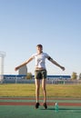 Teenager girl working out at the stadium doing jumping jacks Royalty Free Stock Photo