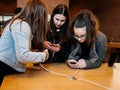 Teenager girls friends testing the latest iphone in Apple Store