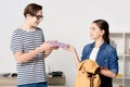 teenager giving book to boy