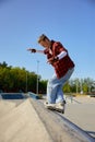 Teenager guy with roller skates performing tricks outdoors Royalty Free Stock Photo