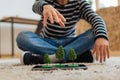 Teenager having tree miniatures on his tablet