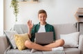 Teenager having videochat on laptop from home