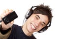 Teenager with headphones shows mp3 music player Royalty Free Stock Photo