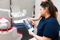 Teenager is hiding peeking out of the wall as dentists look at his x-ray..Boy still does not understand the seriousness of the hea Royalty Free Stock Photo