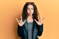 Teenager hispanic girl doing rock gesture relaxed with serious expression on face Royalty Free Stock Photo