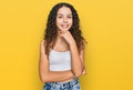 Teenager hispanic girl wearing casual clothes looking confident at the camera with smile with crossed arms and hand raised on chin Royalty Free Stock Photo