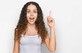 Teenager hispanic girl wearing casual clothes pointing finger up with successful idea