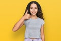 Teenager hispanic girl wearing casual clothes smiling happy and positive, thumb up doing excellent and approval sign