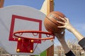 Basketball shot in street game, hands holding ball