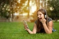 Teenager holding smart phone in hand, screams with joy and happiness Royalty Free Stock Photo